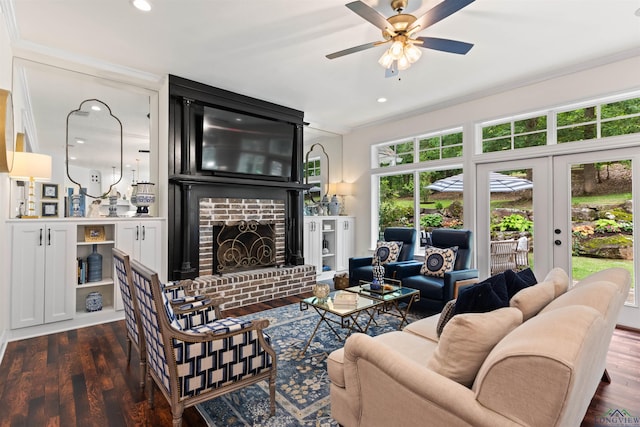 1307 Yates Dr, Longview, TX 75601 - living room with crown molding, a ceiling fan, a brick fireplace, dark wood finished floors, and french doors