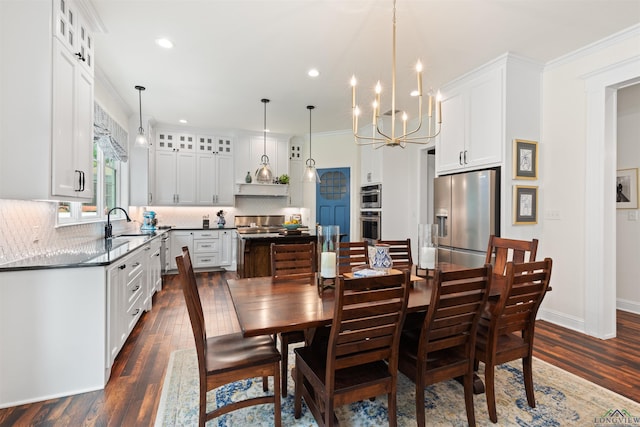 1307 Yates Dr, Longview, TX 75601 - dining area with a chandelier, dark wood finished floors, ornamental molding, and recessed lighting