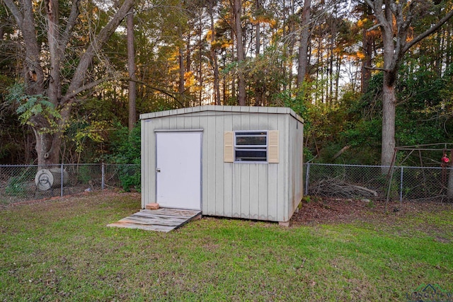 view of outbuilding with a yard