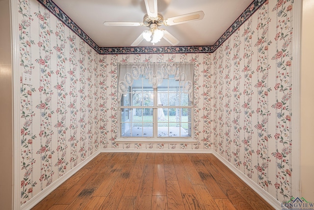 spare room featuring hardwood / wood-style flooring and ceiling fan