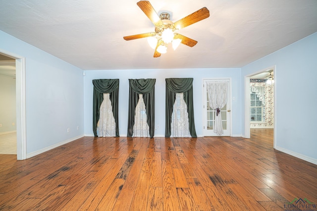 empty room featuring hardwood / wood-style flooring and ceiling fan