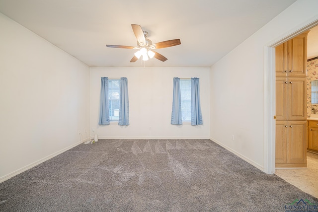 empty room with ceiling fan and carpet