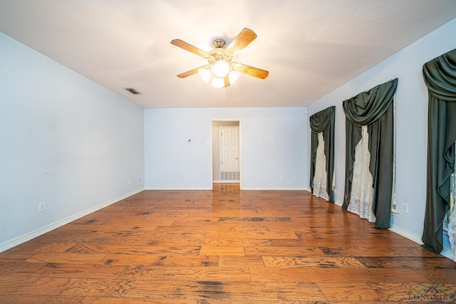 empty room featuring wood-type flooring and ceiling fan