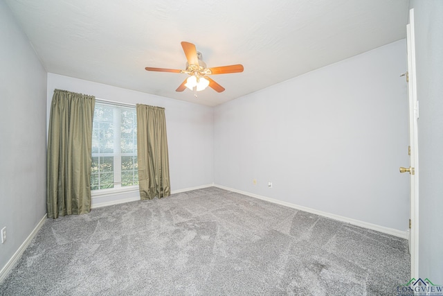 carpeted spare room featuring ceiling fan