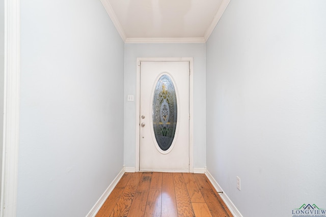 doorway featuring crown molding and hardwood / wood-style flooring