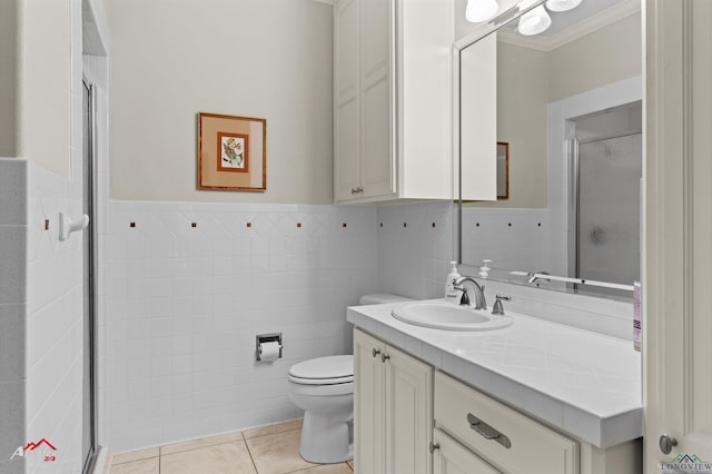 bathroom featuring tile walls, vanity, tile patterned flooring, toilet, and a shower with door