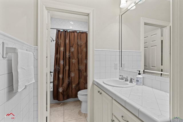 bathroom featuring tile walls, vanity, and toilet