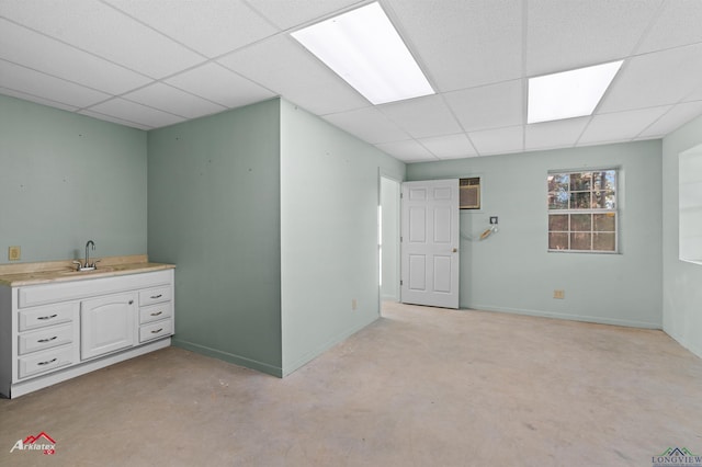 basement featuring sink and a paneled ceiling