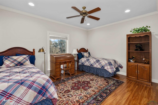 bedroom featuring ceiling fan, crown molding, and wood-type flooring