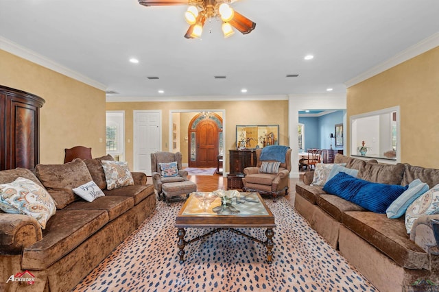 living room featuring ceiling fan and crown molding