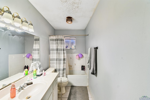 full bathroom featuring vanity, tile patterned flooring, toilet, a textured ceiling, and shower / tub combo with curtain