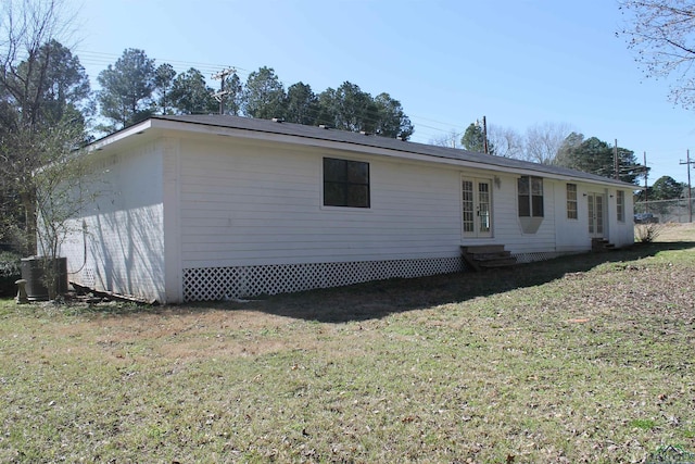 exterior space with entry steps, a yard, and central air condition unit