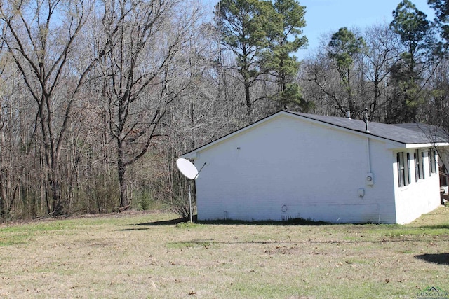 view of property exterior with a yard