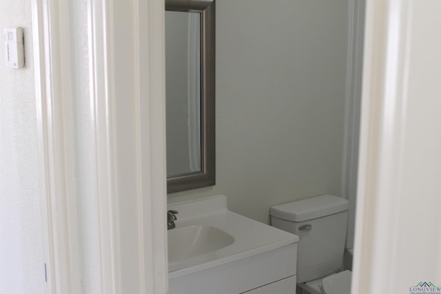 half bath with vanity and toilet