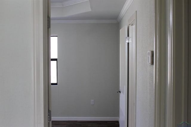 interior space with dark wood finished floors, crown molding, and baseboards