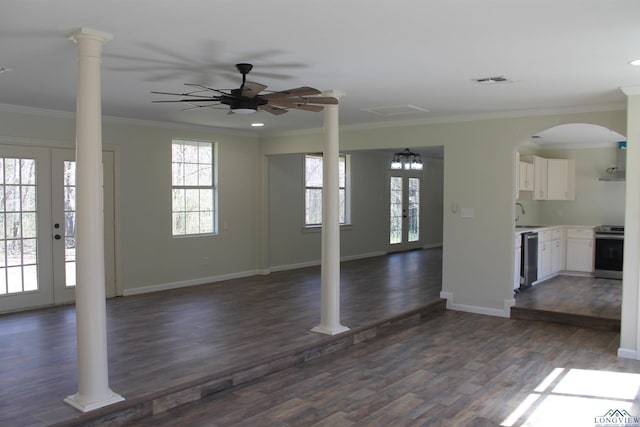 unfurnished living room featuring dark wood-style floors, french doors, crown molding, visible vents, and ornate columns