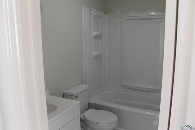 bathroom featuring  shower combination, vanity, and toilet