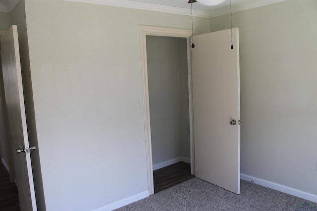 unfurnished bedroom with carpet, ornamental molding, and baseboards