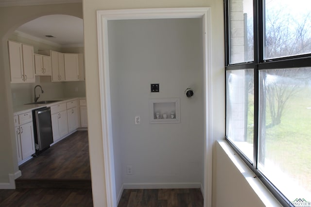 washroom featuring washer hookup, arched walkways, dark wood finished floors, hookup for an electric dryer, and a sink