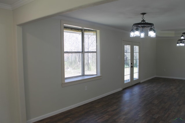 unfurnished dining area featuring french doors, ornamental molding, dark wood finished floors, and baseboards