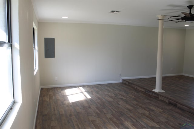 spare room featuring ceiling fan, visible vents, baseboards, electric panel, and crown molding