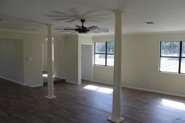 spare room featuring ornamental molding, arched walkways, ceiling fan, and ornate columns