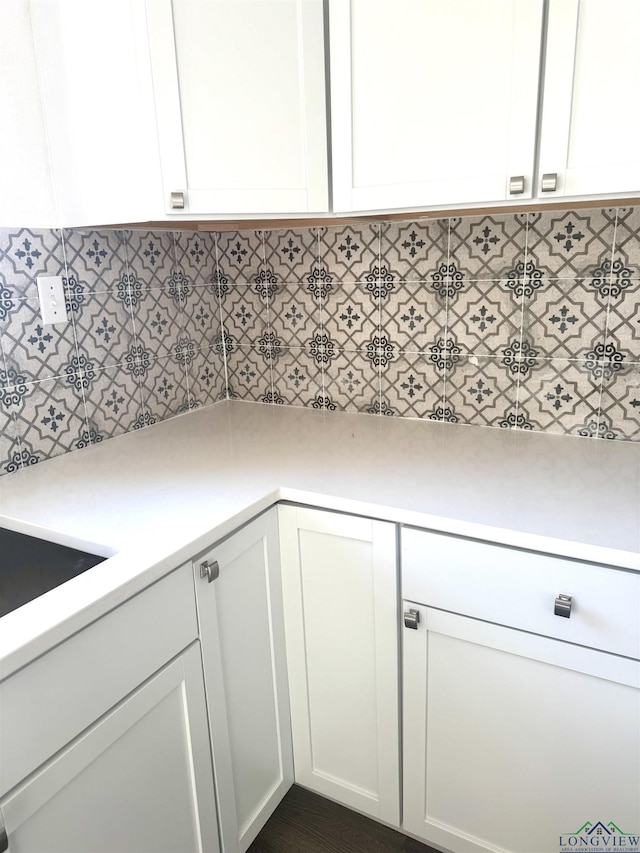 kitchen featuring white cabinets and backsplash