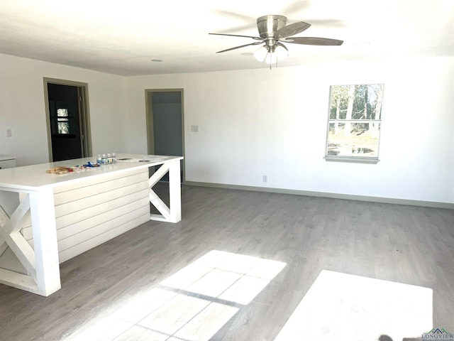 unfurnished living room with light hardwood / wood-style floors and ceiling fan