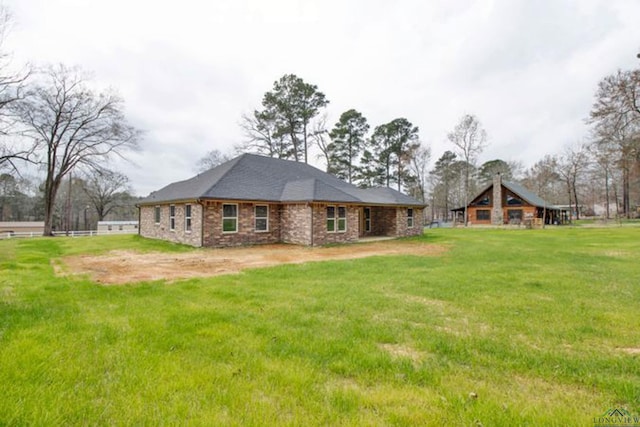 rear view of property with a lawn