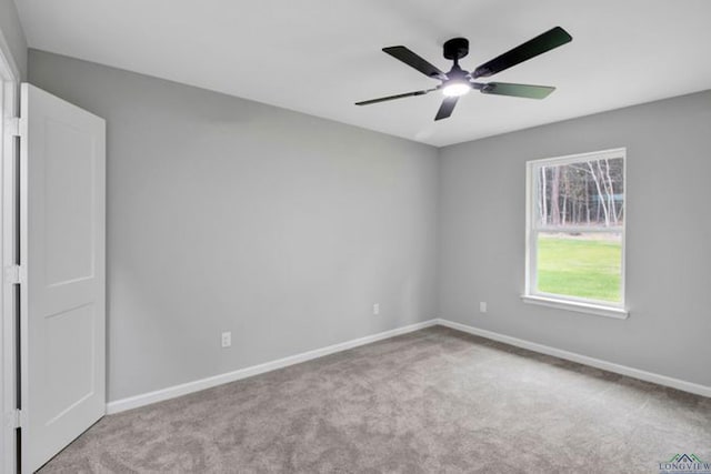 carpeted empty room featuring ceiling fan