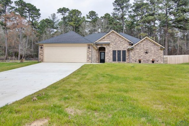 view of front of home featuring a garage and a front yard