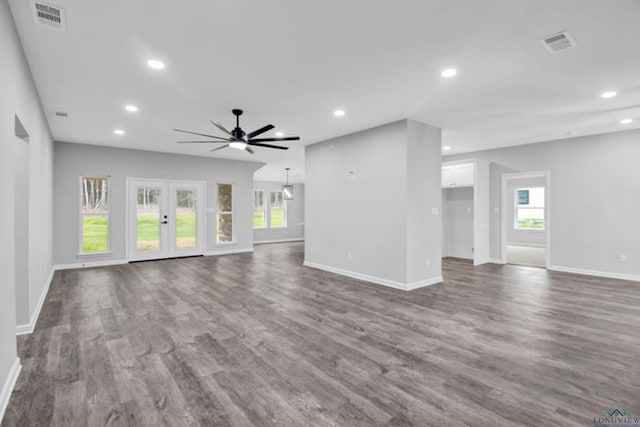 unfurnished living room featuring dark hardwood / wood-style flooring, french doors, and ceiling fan