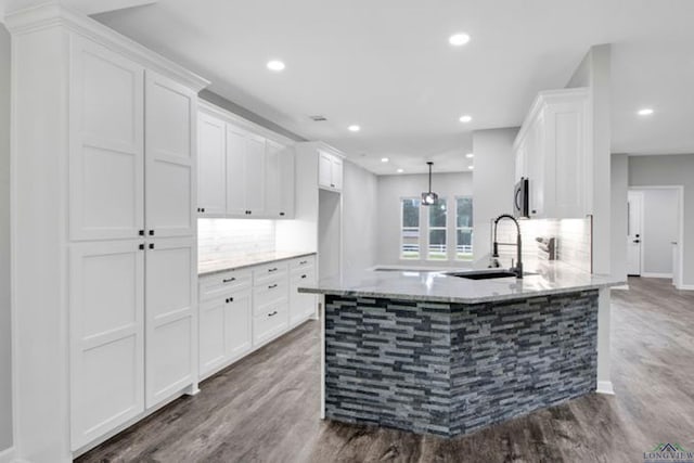 kitchen with white cabinetry, sink, pendant lighting, and dark hardwood / wood-style floors