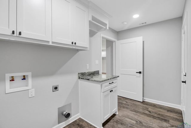 washroom featuring electric dryer hookup, hookup for a washing machine, dark wood-type flooring, and cabinets