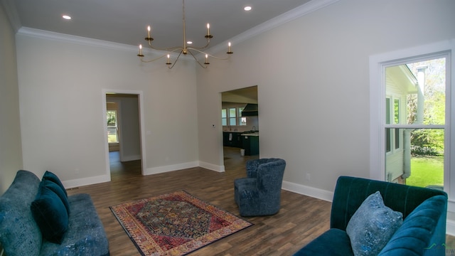 living room with crown molding, plenty of natural light, and dark wood-type flooring