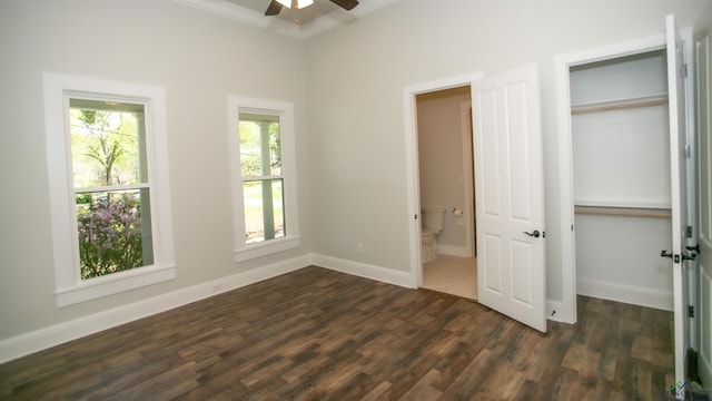 unfurnished bedroom featuring dark hardwood / wood-style floors, ceiling fan, ornamental molding, and ensuite bathroom