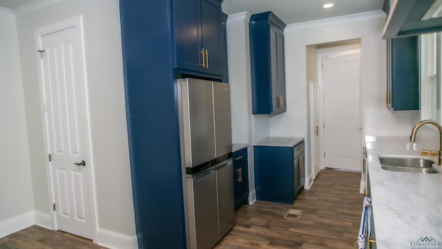 kitchen with decorative backsplash, stainless steel fridge, dark hardwood / wood-style flooring, sink, and blue cabinetry