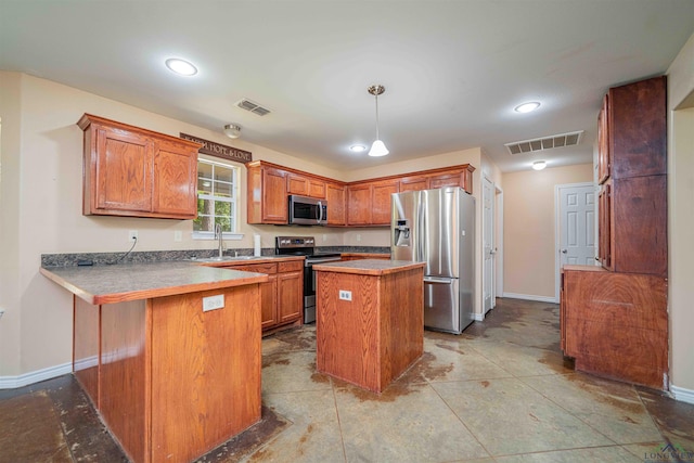 kitchen with visible vents, appliances with stainless steel finishes, brown cabinetry, and baseboards
