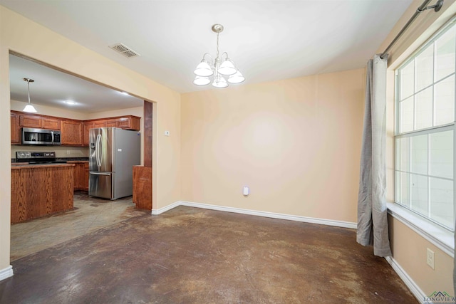 kitchen with appliances with stainless steel finishes, baseboards, visible vents, a notable chandelier, and concrete flooring