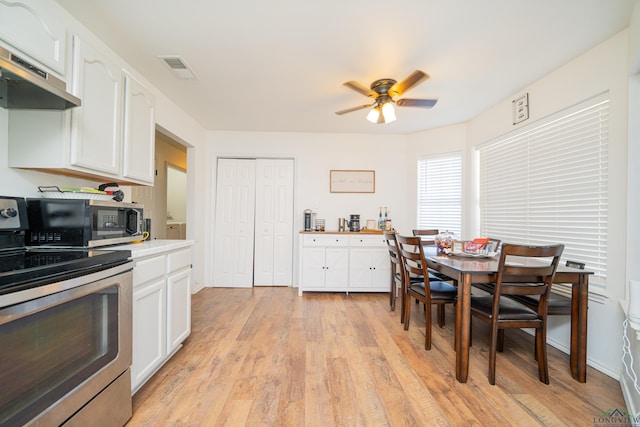 520 Morning Glory Cir, Hughes Springs, TX 75656 - kitchen featuring a ceiling fan, light wood-style flooring, stainless steel appliances, light countertops, and white cabinetry