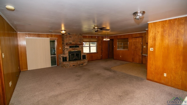 unfurnished living room featuring ceiling fan, carpet floors, and wooden walls