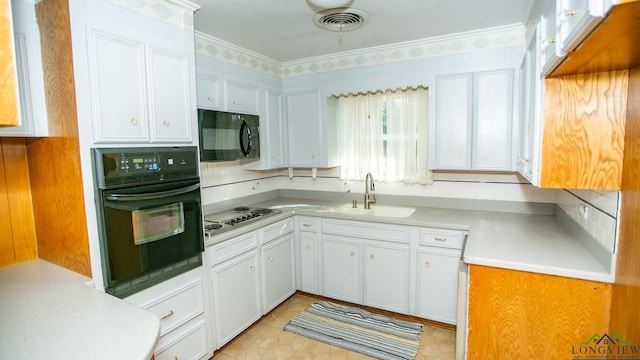 kitchen with white cabinetry, sink, light tile patterned floors, and black appliances