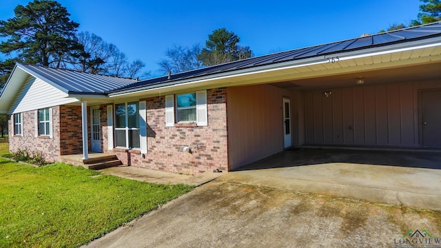 ranch-style house with a front yard and a carport