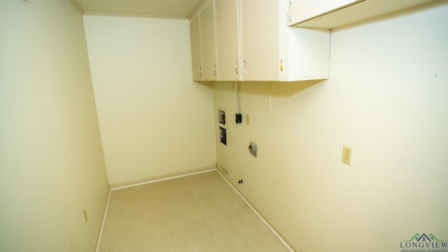 washroom featuring cabinets, ornamental molding, light colored carpet, and hookup for an electric dryer