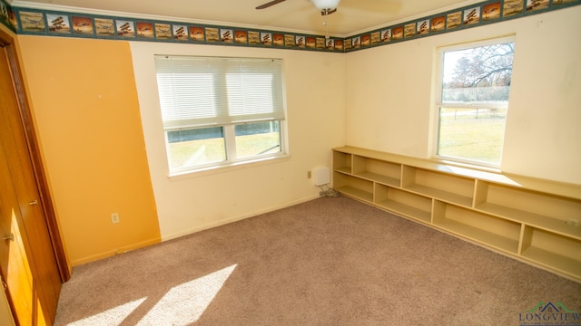 carpeted empty room with ceiling fan