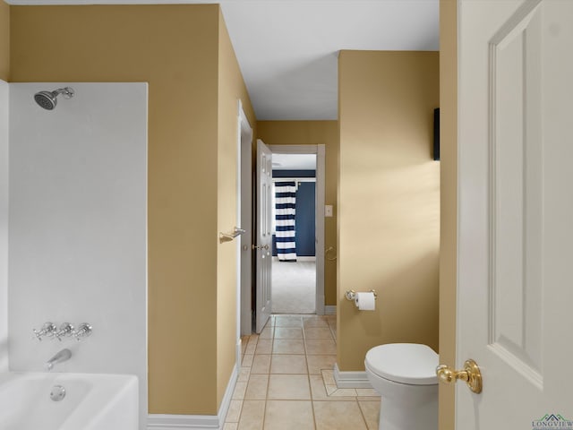 bathroom with tile patterned floors, toilet, and washtub / shower combination