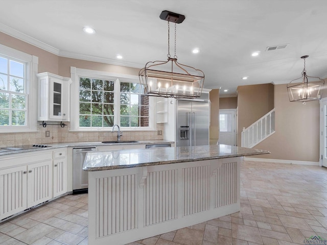 kitchen featuring white cabinets, a kitchen breakfast bar, a center island, and stainless steel appliances