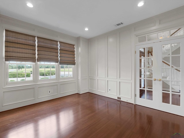 spare room featuring french doors and hardwood / wood-style floors