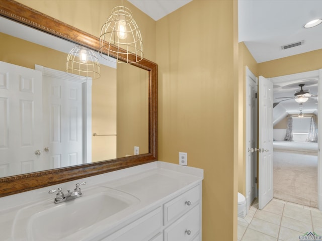 bathroom featuring toilet, vanity, tile patterned floors, and ceiling fan