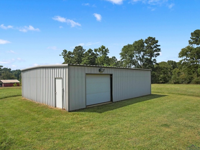 view of outdoor structure featuring a lawn and a garage